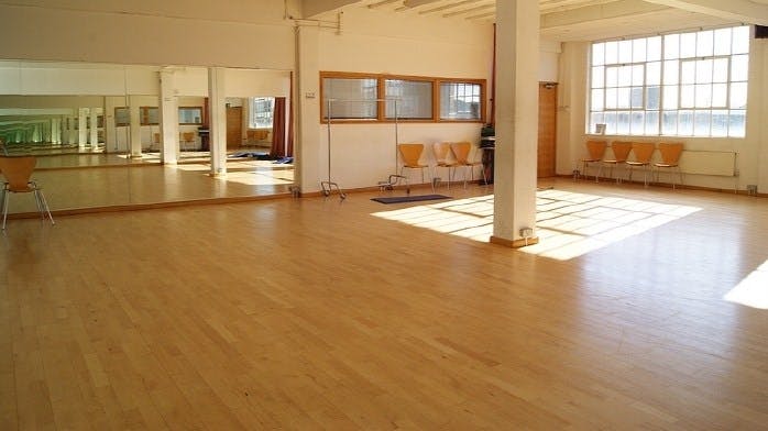 Spacious STUDIO 2 with wooden floors, ideal for workshops and fitness classes.